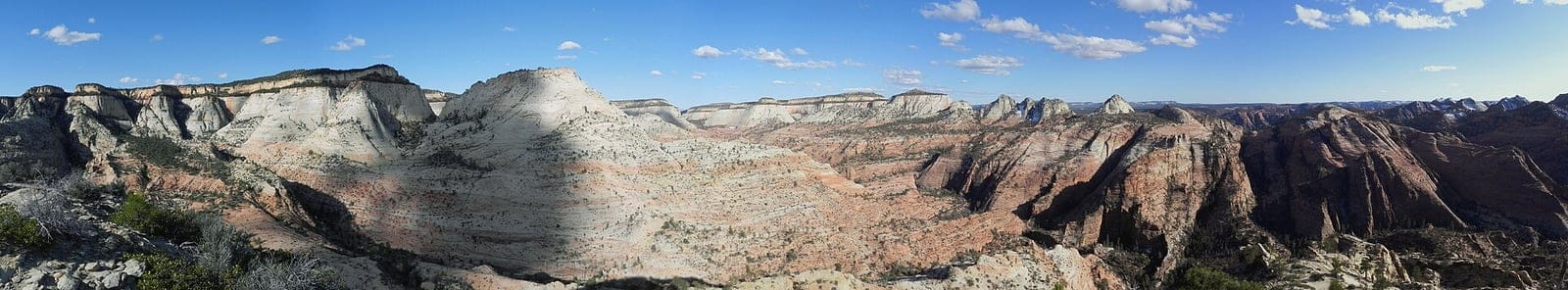 Panoramic View from Progeny Peak, Zion National Park Sweeping panoramic view from Progeny Peak showing white sandstone domes and red rock canyons in Zion National Park.