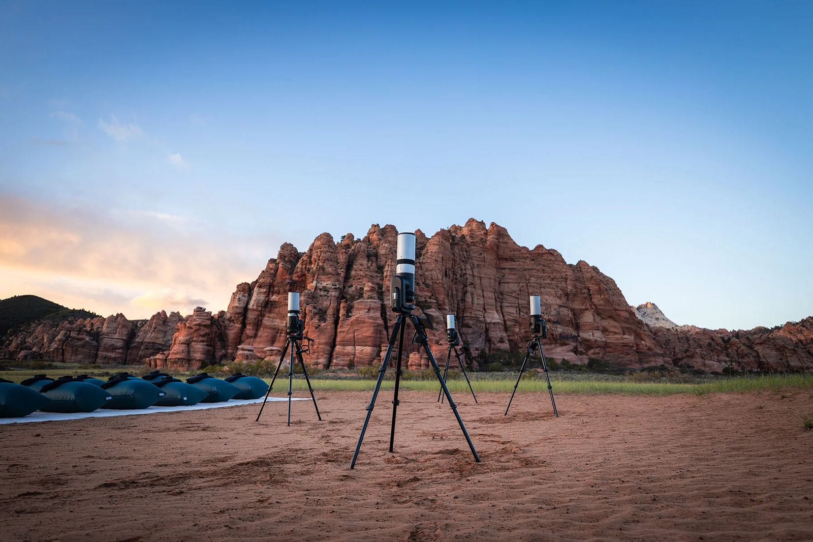 Stargazing at Sunset in Zion National Park A scenic overlook in Zion National Park with red rock formations and telescopes set up for stargazing at sunset.