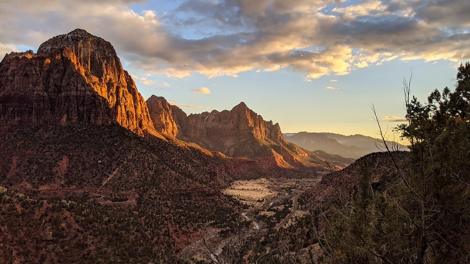 Sunset Over the Watchman, Zion National Park Golden sunset light bathes the Watchman and sandstone cliffs above Zion Canyon in southern Utah.