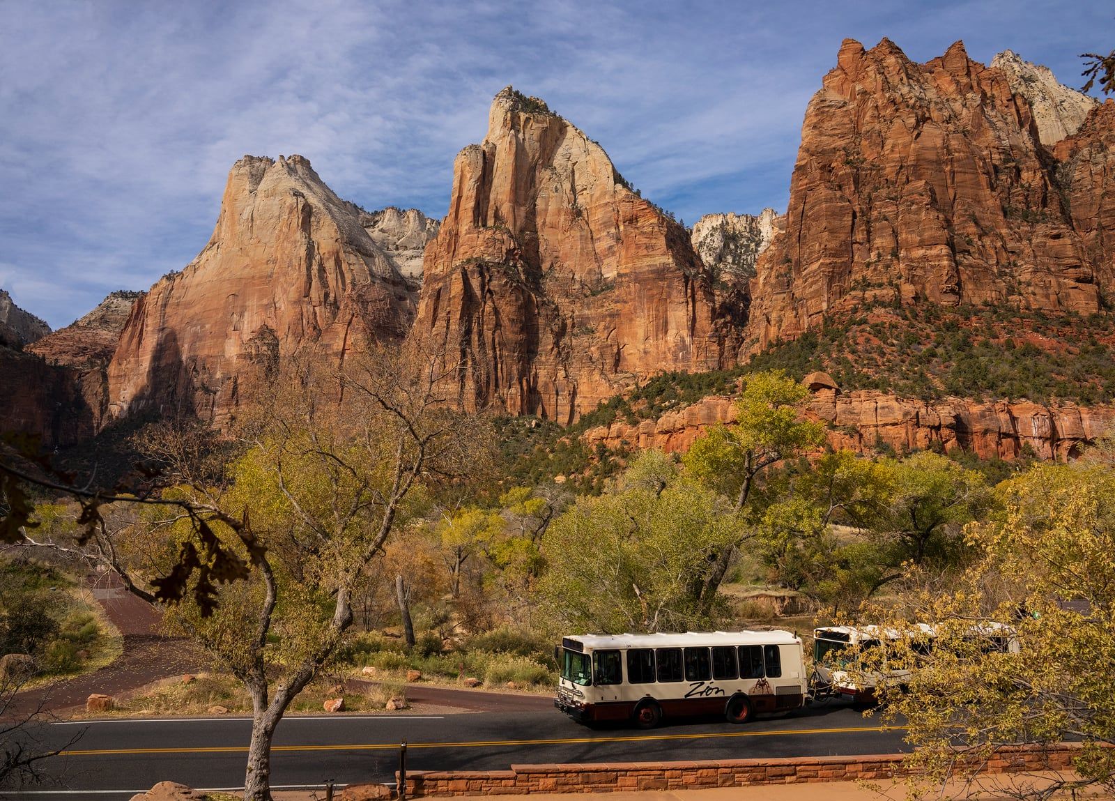 Zion Shuttle Bus at Court of the Patriarchs A Zion National Park shuttle bus travels the scenic drive beneath the towering Court of the Patriarchs sandstone formations.