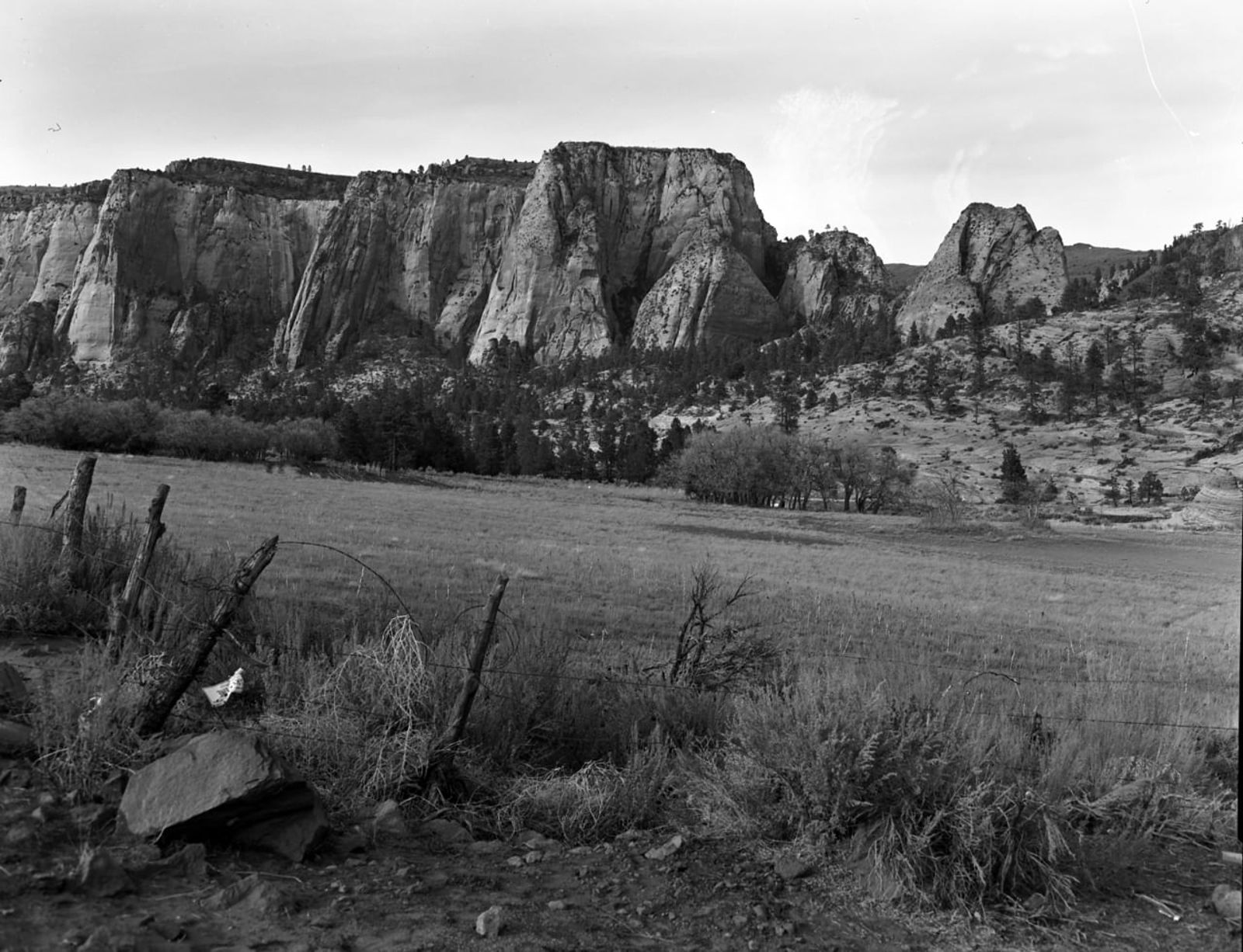 Historic Kolob Terrace Cliffs and Ranch Meadow Vintage black and white view of Kolob Terrace sandstone cliffs rising above a fenced ranch meadow in southern Utah.