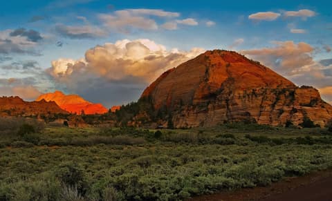 Tabernacle Dome rises above sagebrush flats at golden hour in Zion National Park, Utah.